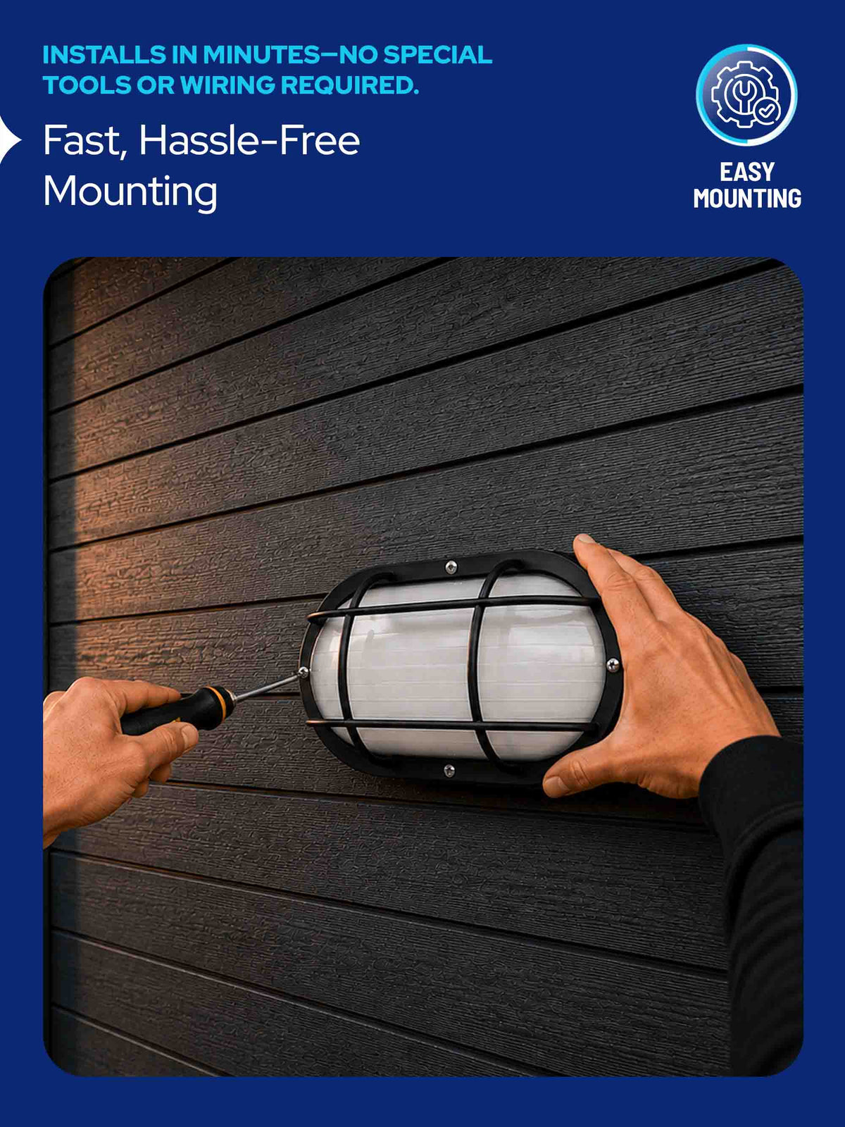 A black outdoor wall light fixture with a frosted white glass shade being mounted on dark horizontal siding by two hands using a screwdriver. The image has a blue border with text reading 'INSTALLS IN MINUTES—NO SPECIAL TOOLS OR WIRING REQUIRED.